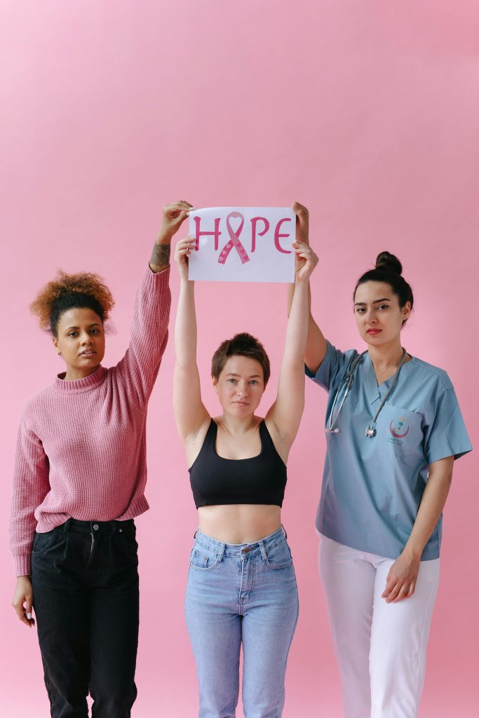 Three diverse women promoting breast cancer awareness with a hopeful message.